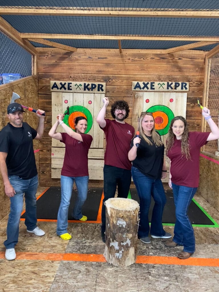 Group enjoying axe throwing activity.