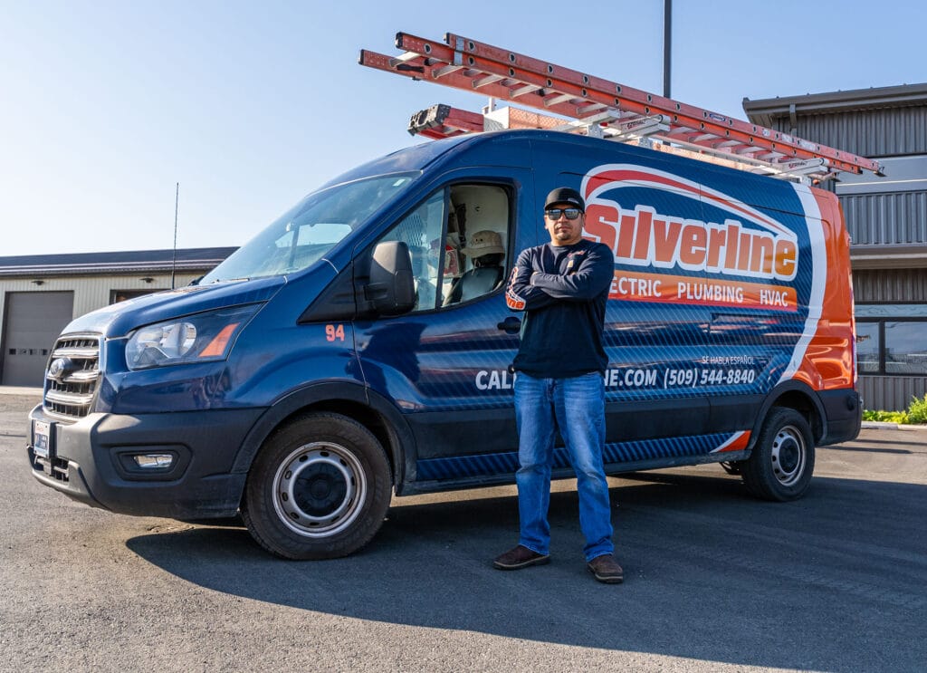 Silverline service van with employee outside building