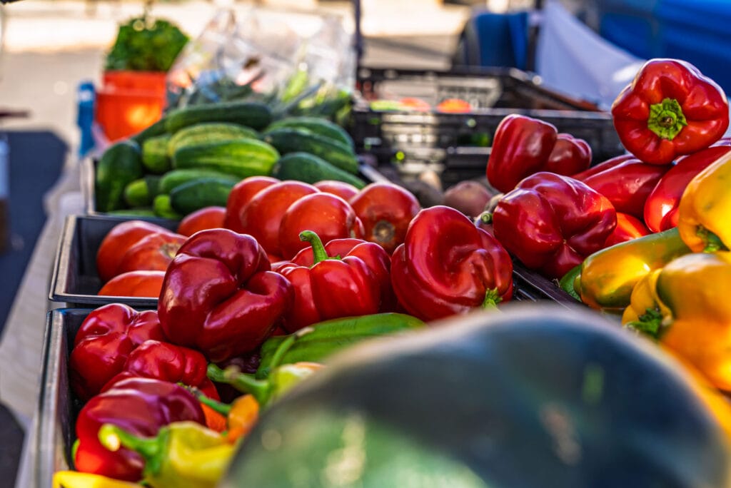 Fresh vegetables at a farmers market stall.