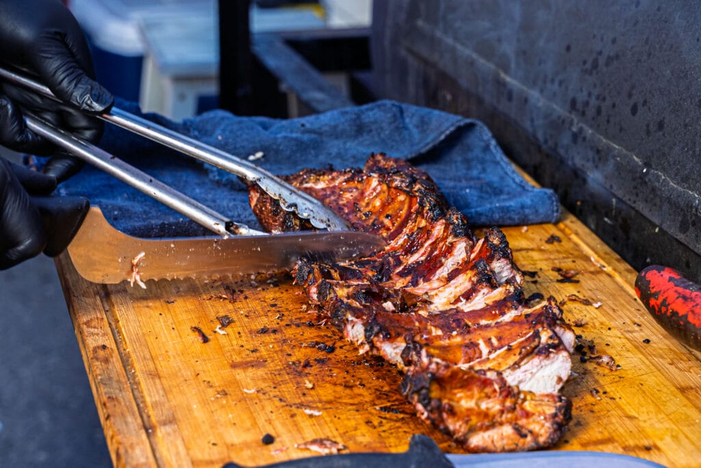 Sliced grilled ribs on cutting board