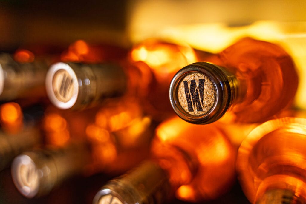 Stacked wine bottles in warm lighting