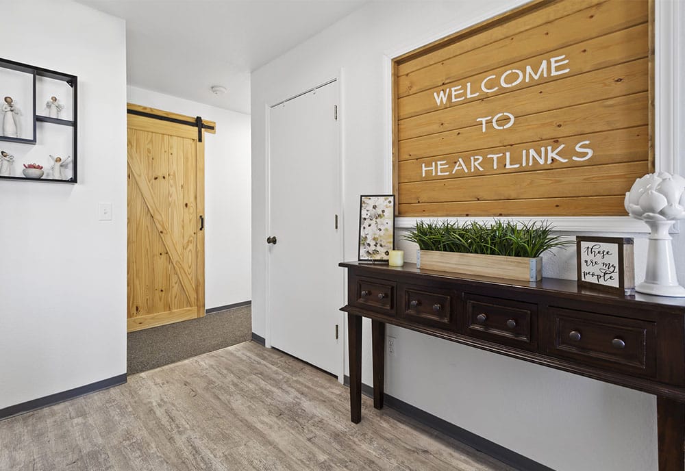 Welcoming hallway with wooden decor and plants.