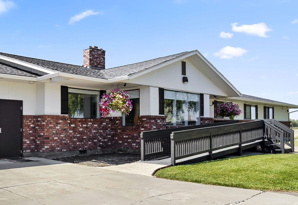 Accessible brick house with wheelchair ramp.