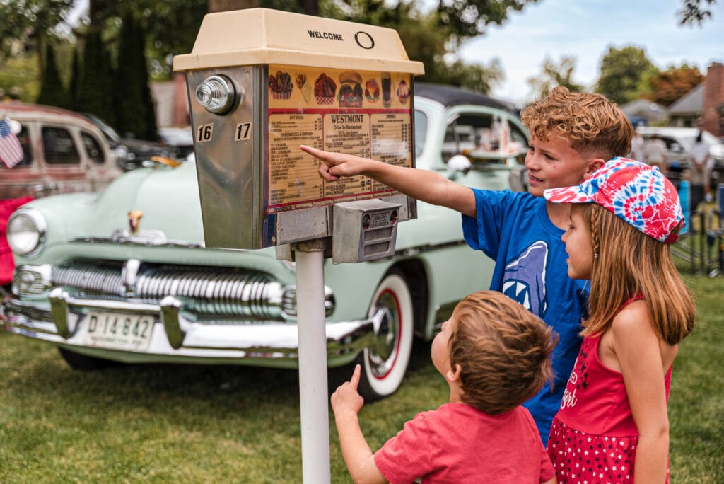 Kids choosing from drive-in restaurant menu