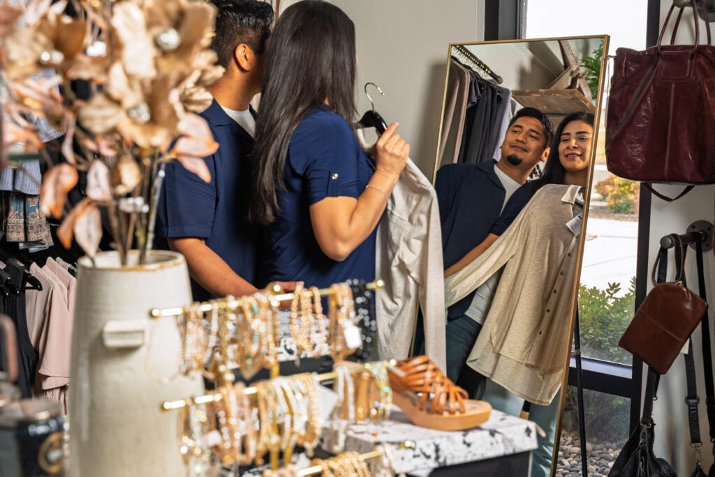 Couple shopping for clothes, mirror reflection.