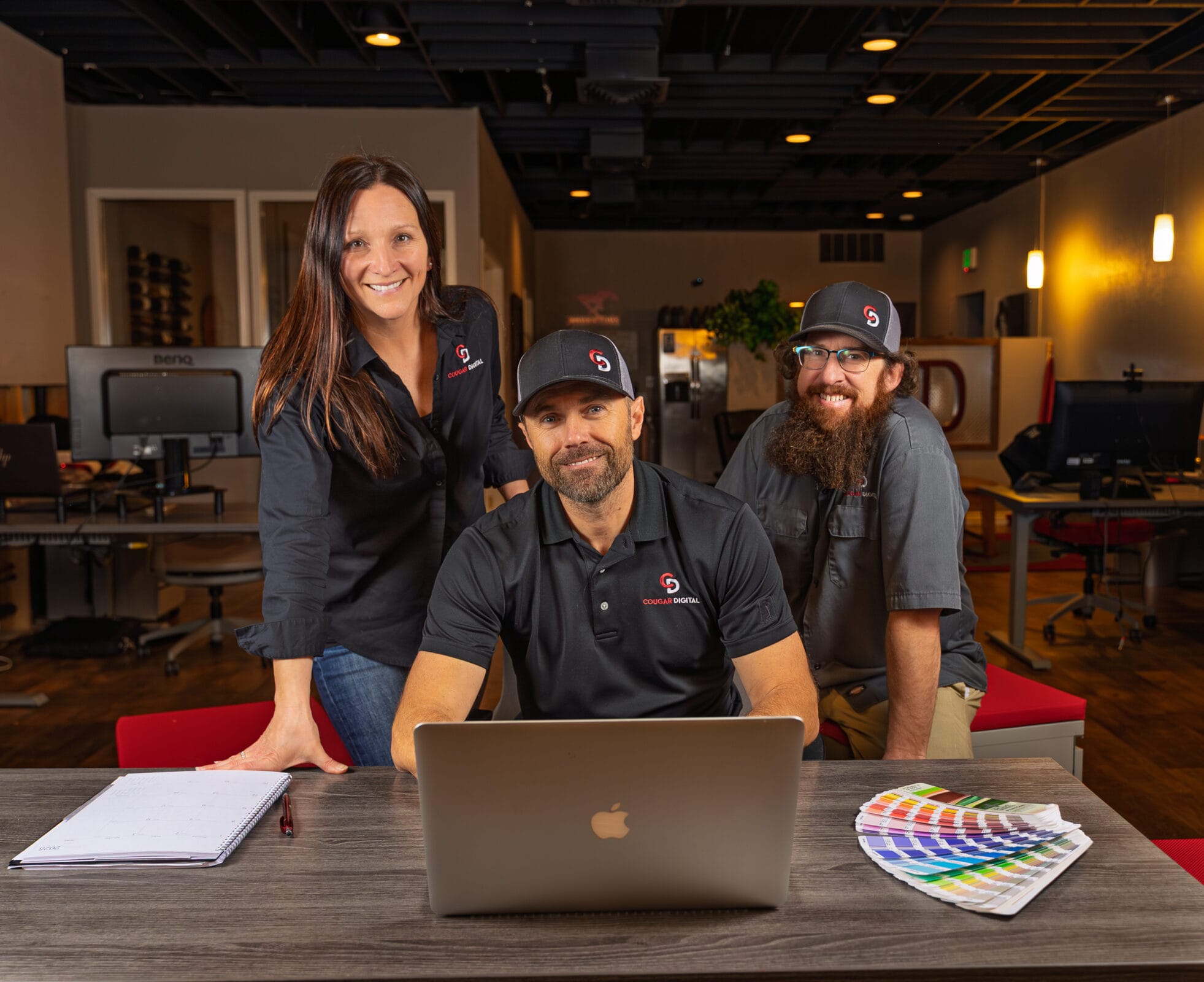 Team in office with laptop and color palette