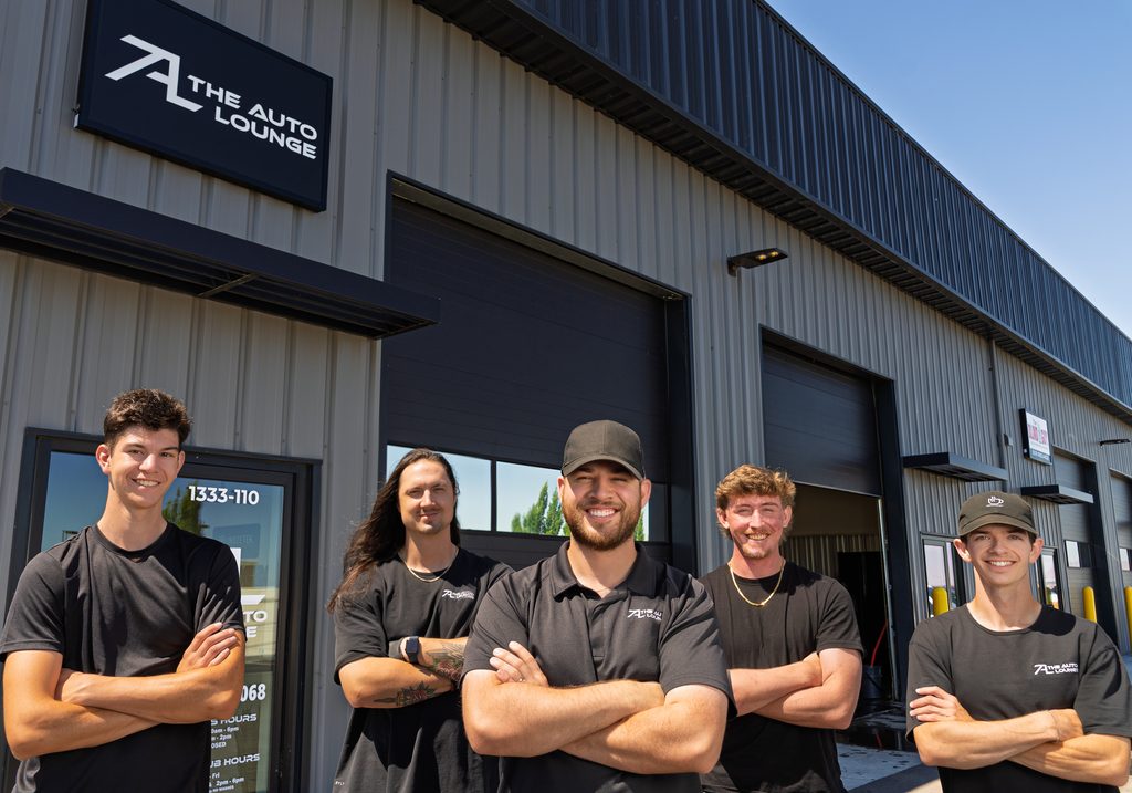 The Auto Lounge team posing outside their auto shop
