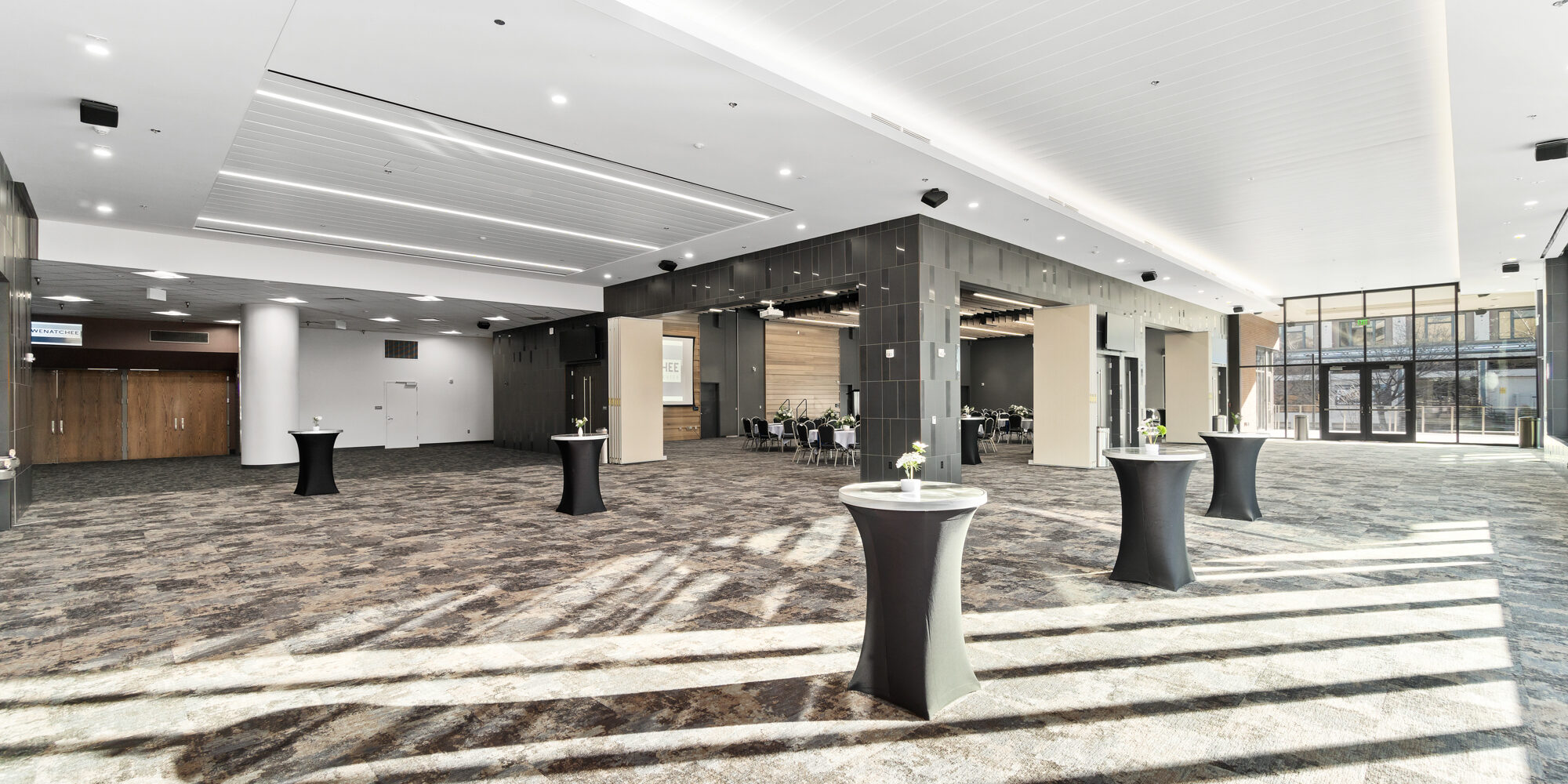 Spacious convention center lobby with cocktail tables