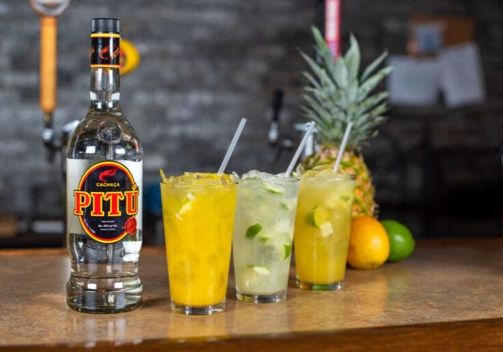 Three cocktails with cachaça and tropical fruits
