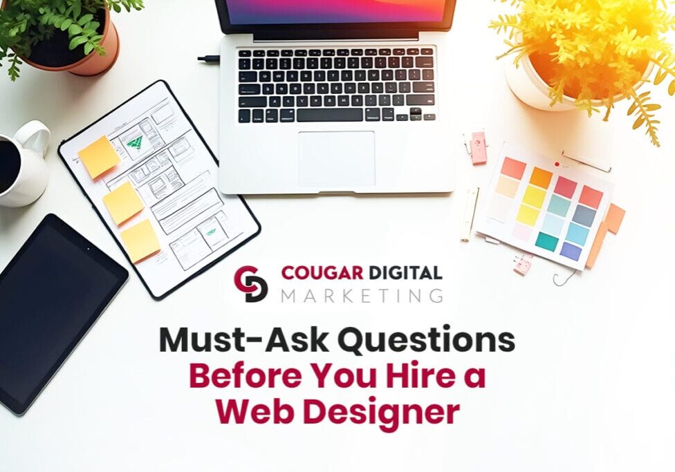 Web design hiring questions and design tools on table.